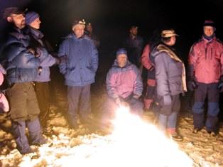 Snow Survey Training School group students huddle around the campfire at their Granlibakken retreat in 2009.