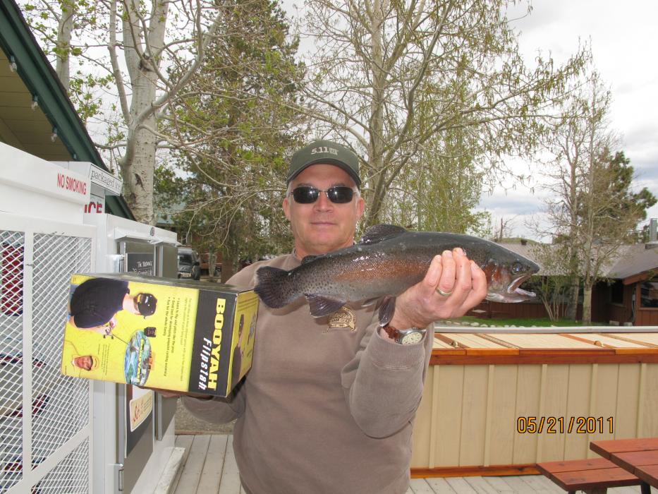 A fisherman holds a nice sized rainbow trout caught at Convict Lake, Calif.  Photo courtesy of the Convict Lake Resort