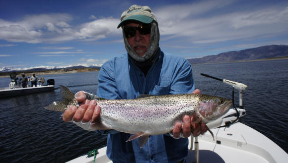 Lee Deminski with a rainbow at Crowley Lake. Photo by Sierra Drifters Guide Service