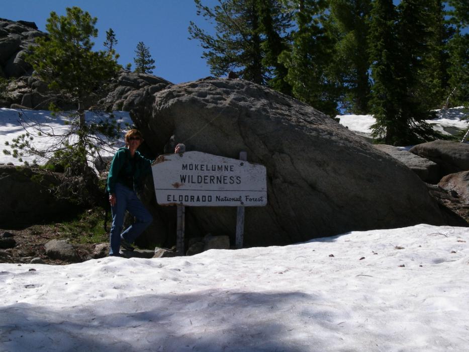 Elaine Quilici of Carson City standing next to an old sign for the Mokelumne Wilderness Area in California. Photo by Don Quilic