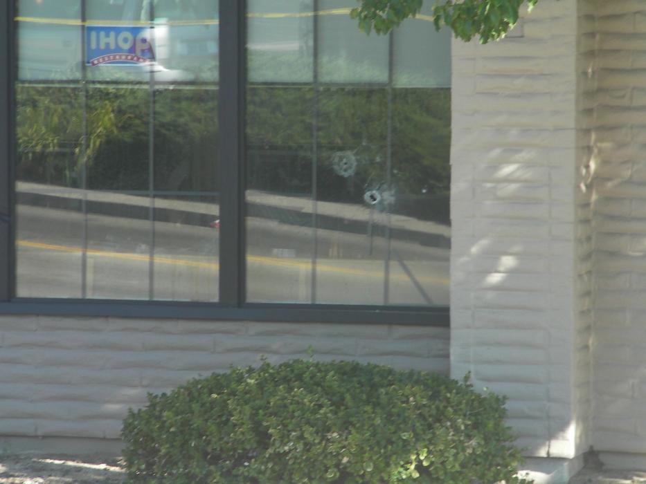 A bullet hole can be seen in a window on the south side of the IHOP