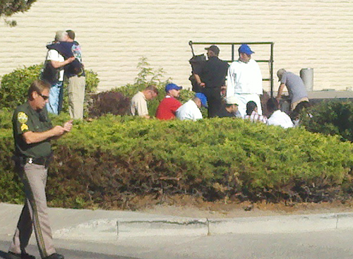 Witnesses are gathered in back of the IHOP restaurant after the shooting
