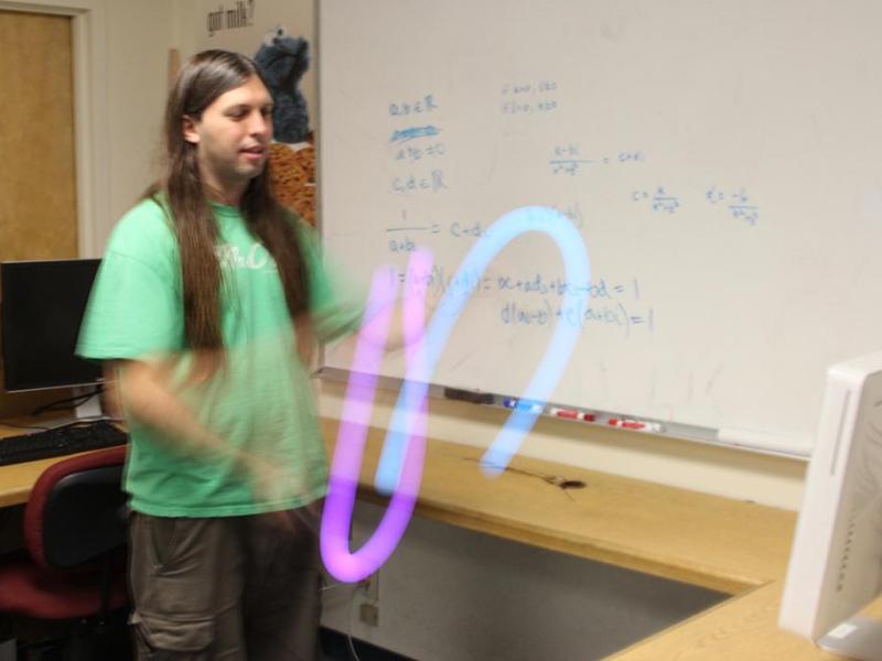 UNR doctoral student Tony Morelli demonstrates target acquisition using two Sony Move controllers. Photo by Mike Wolterbeek