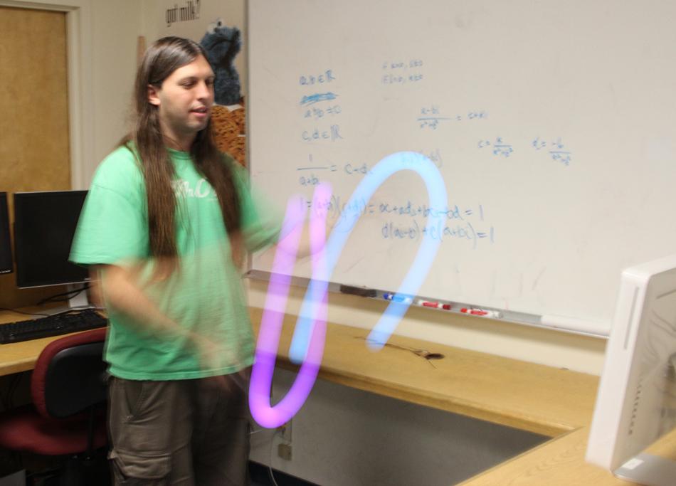 UNR doctoral student Tony Morelli demonstrates target acquisition using two Sony Move controllers. Photo by Mike Wolterbeek