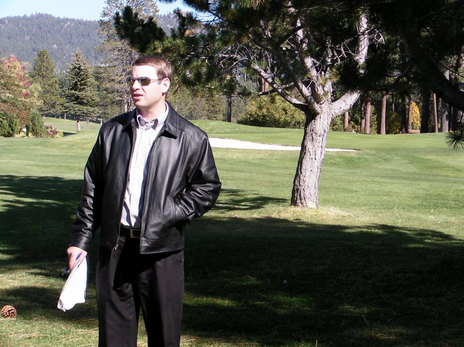 Project Manager Brandon Hill stands where the event lawn will be in relation to the 9th hole which will be moved.
