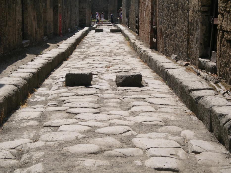 An old cobblestone street in the ruins of Pompeii, where you can see the ruts.  Photo by Don Quilici
