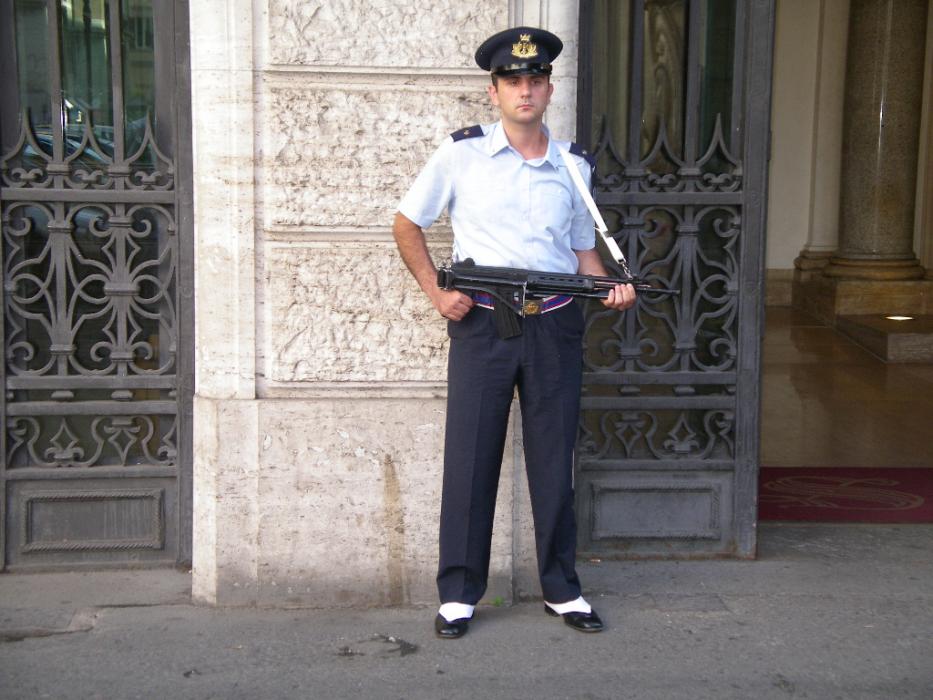 An armed guard stands guard at a bank in Rome. This is a common sight at banks in Italy.  Photo by Don Quilici