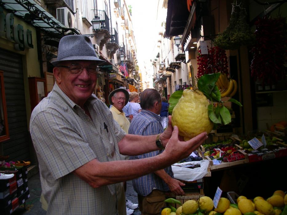 Don Quilici holds a giant, fresh lemon at an outdoor fruit and vegetable stand in Sorrento. Photo by Elaine Quilici