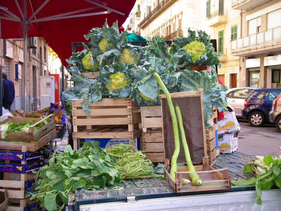 An outdoor vegetable stand in Palermo.  The long skinny vegetables are a form of Zucchini Squash. Photo by Don Quilici