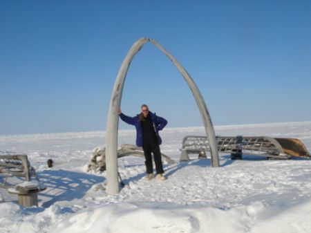 A tourist poses in the middle of the jawbones of a Bowhead Whale at Barrow. Photo courtesy of mcmurren.org