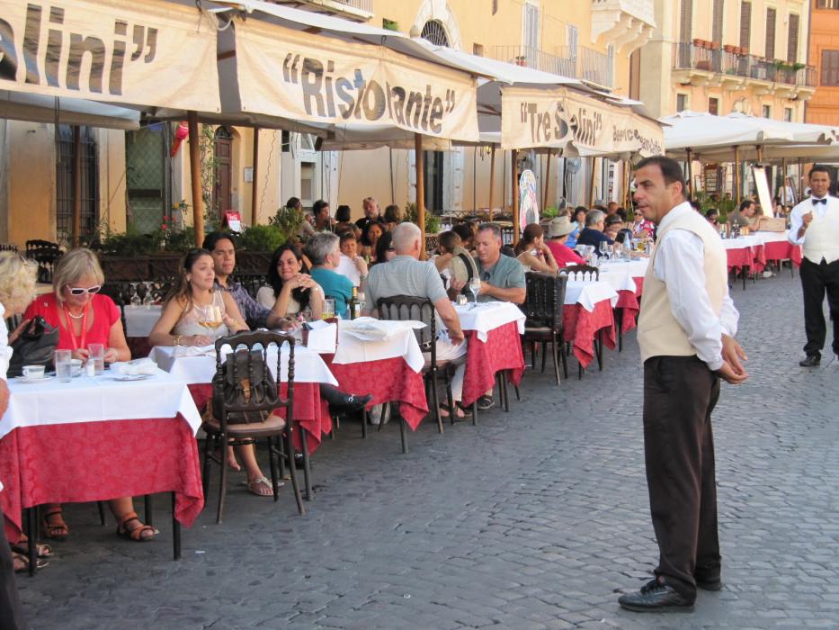 Diners who each paid a seating fee of $6 to sit at outdoor tables at a plaza in Rome. Photo by Don Quilici