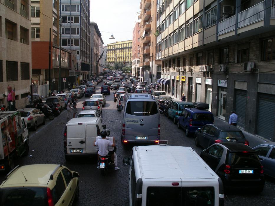 A busy city street in downtown Naples.  Note the two pedestrians trying to cross against the traffic. Photo by Don Quilici