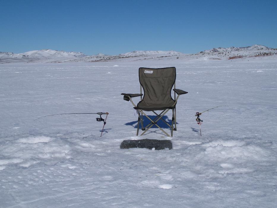 Two holes dug in the ice, two rods and reels, two rod holders, a folding chair and a small rug. Photo by Don Quilici