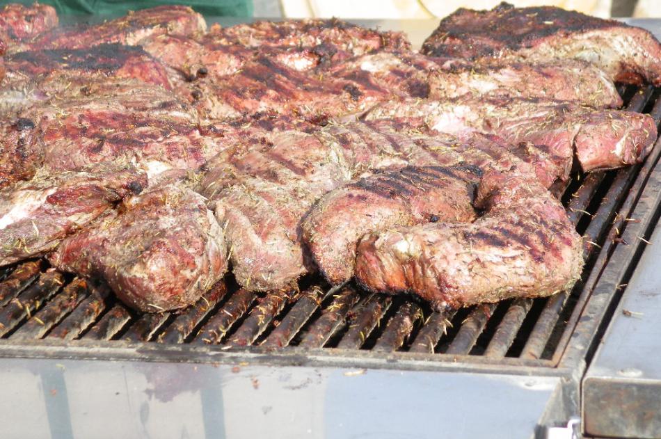 A number of Tri-Tip roasts cooking on the barbecue at that fundraiser. They would be sliced for tri-tip sandwiches.