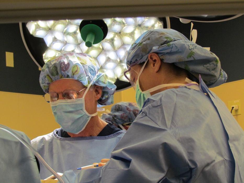 Terrence Orr, M.D. and Nicole Cleaves, R.N. perform knee surgery in the Barton operating room.
