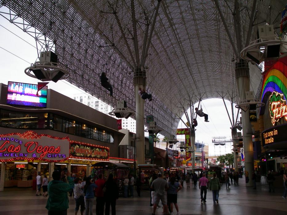 Some tourists, high over head, enjoying the Zip Line as part of the Fremont Experience in downtown Las Vegas.