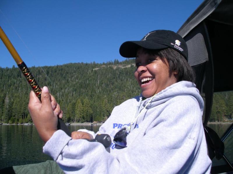 A delighted fisherwoman trying to bring in her trout.  Photo by Don Quilici
