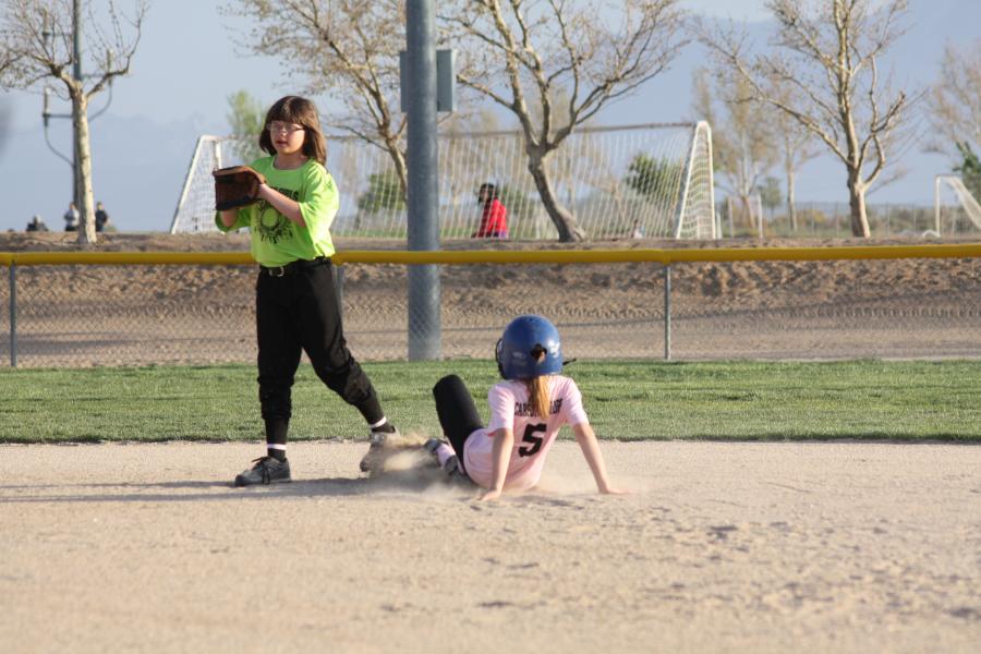 Hailee Bauman sliding into second with Killer Kiwi shortstop Marissa Hein at the ready