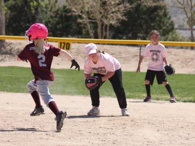 Savanna Sharp fielding at 2nd with backup by Annabelle Crawford and baserunner Mak Wells
