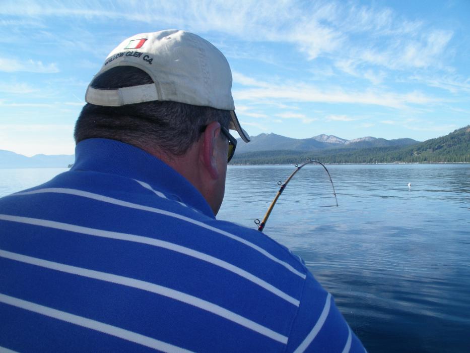 Rob Boehmer reeling in his first trout of the day.  Photo by Don Quilici