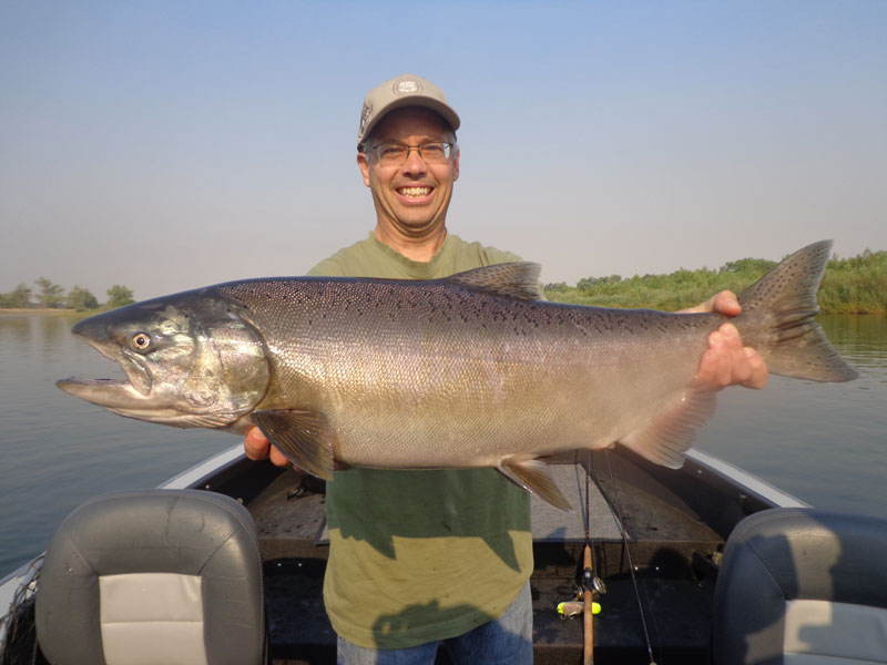A very happy fisherman with his King Salmon caught in the Sacramento River on August 22. Photo by Kirk and Lisa Portocarrero