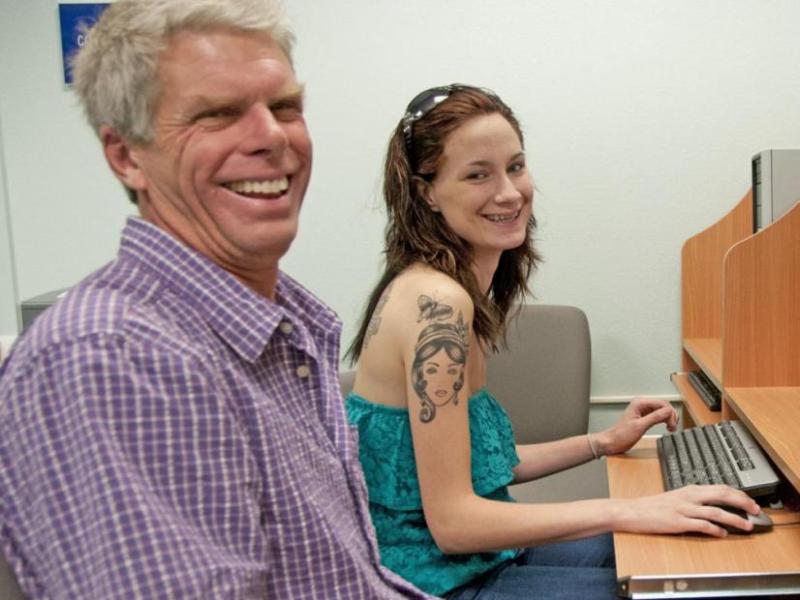Peer Mentor Don Boebel, left, assists a new student.