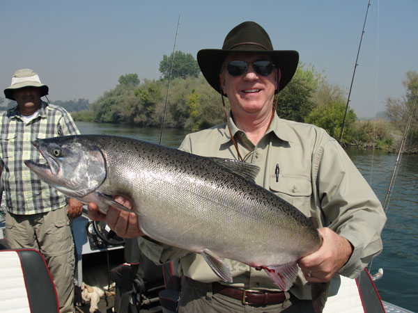 A happy angler with his King Salmon caught on the Sacramento River. Photo courtesy of Kirk and Lisa Portocarrero