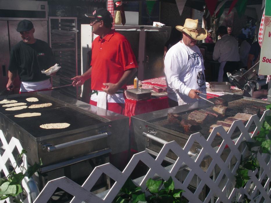 Two cooks busy cooking flat bread and Tri Tip roasts. Photo by Elaine Quilici