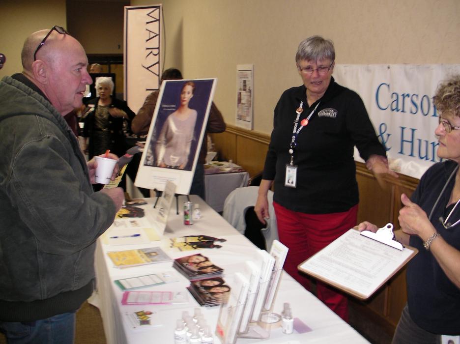 Ken Wilson learns about flu shots by Carson City Health & Human Services staff.