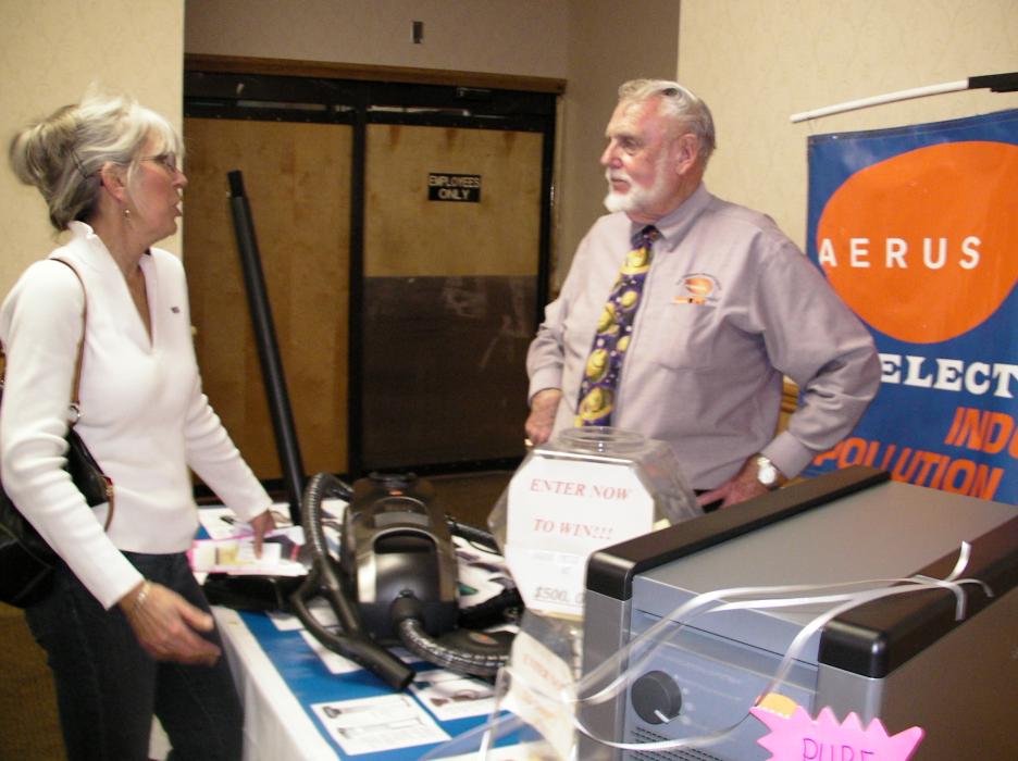 Evie Dean of Dayton stops by the Aerus Electrolux display and talks with Dave Churchey.