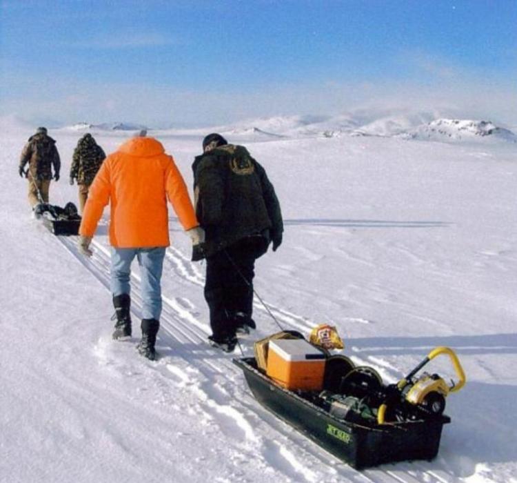 Fishermen venturing out onto the ice for a day of fishing.  Photo by Mark Day