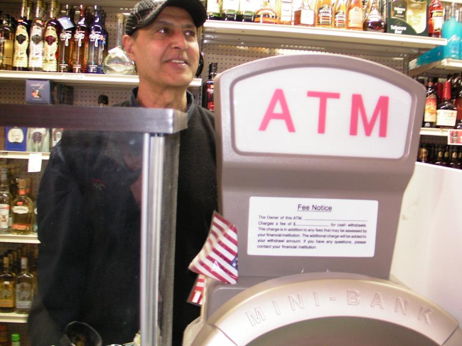 Randy Cheeme, owner of Capital Liquors says he lost business because of phone issues tied to ATM and debit card machines.