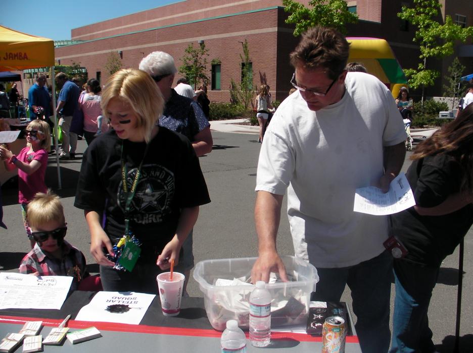 DARE kid Madelynn Dixon and Rob True of Carson City check out the information table.