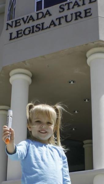 Sydney Larsen, 3, holds a 'Epi-pen' after testimony.