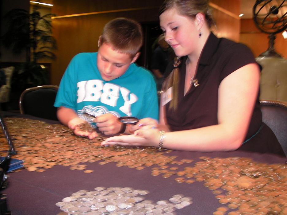 Emerson and Emily Spence of Carson City studies a batch of coins.