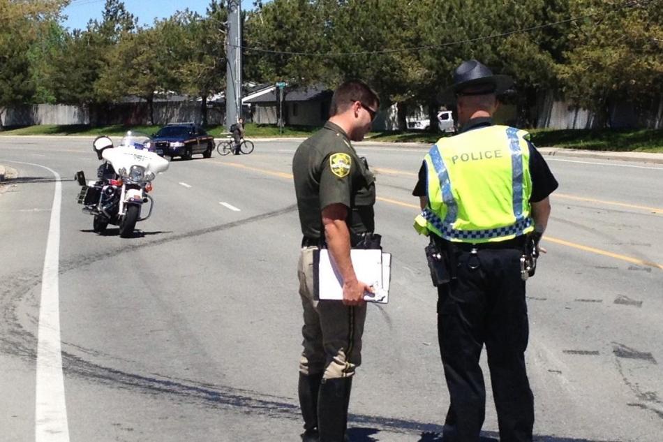 Carson City Sheriff's officers investigate the skid marks associated with the rollover.