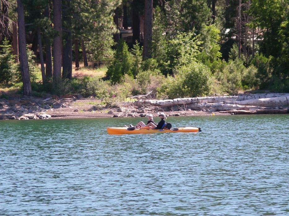Two kayakers paddling along the east shore of Lake Almanor.  Photo by Elaine Quilici