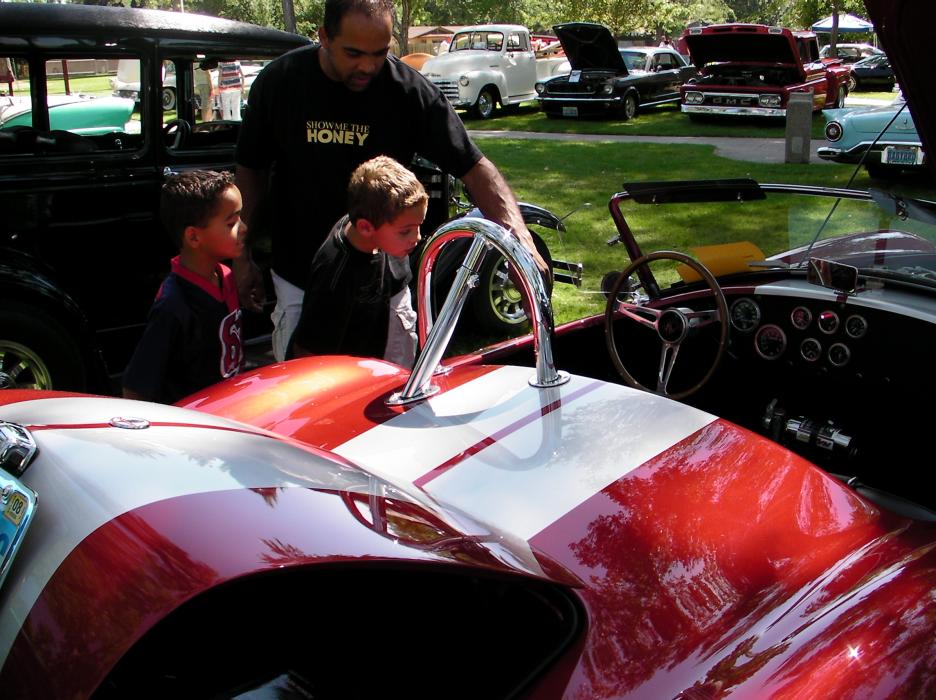 James Williams takes boys Nicholas Jaramillo and Kobe Saunders on the car show tour.
