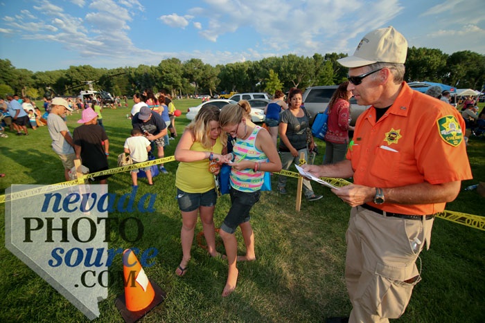 Matt Medeiros watches as Mary Frayo, left, and Jazmin Estes, go through the compass course. Photo by Cathleen Allison