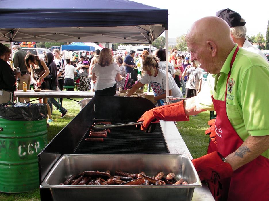 Elks Lodge #2177 cooks up hotdogs for thousand of attendees Tuesday.
