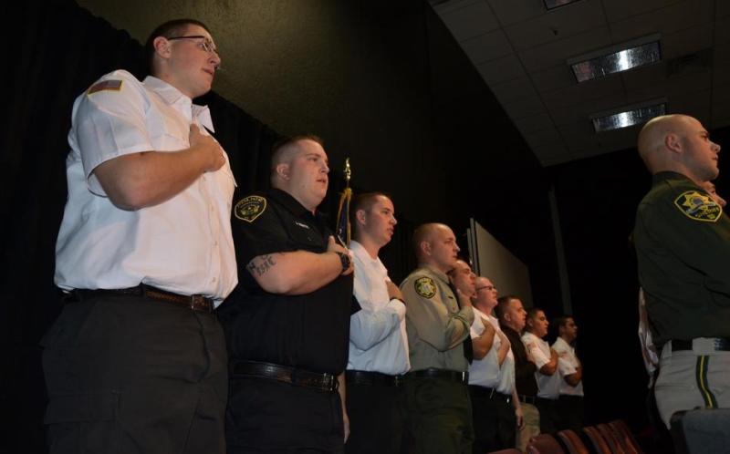 Graduates recite the Pledge of Allegiance.