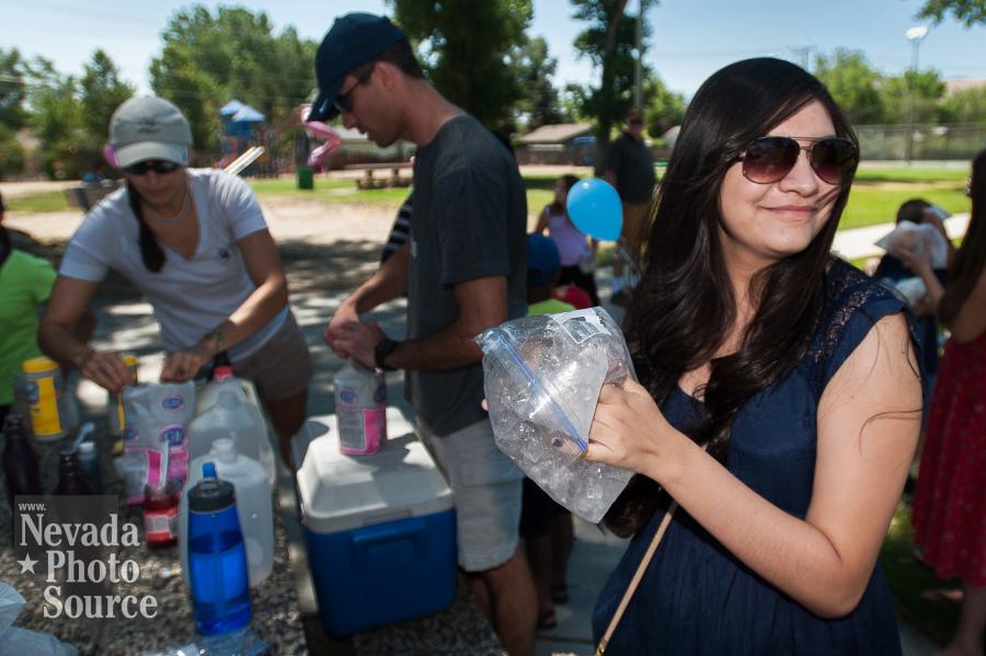 Joana Peraza, 16, volunteers by helping children make homemade ice cream during the Summer Reading Program Ice Cream Party.