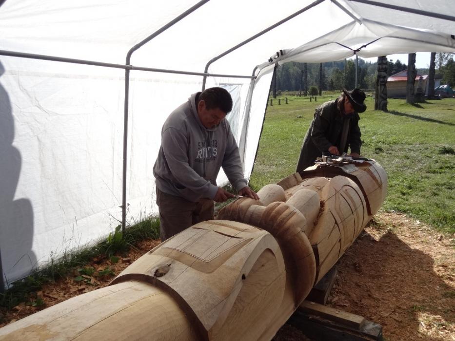 Native artisans carving a new totem pole. Photo by Elaine Quilici