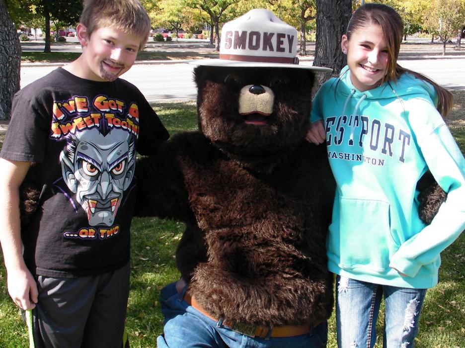 Luke Konrad, 11, and Ashleigh Foster, 14, get face time with Smokey Bear.