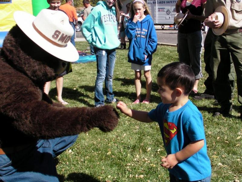 Landon Gauge-Kizer, 3, gets a fist bump from Smokey Bear.
