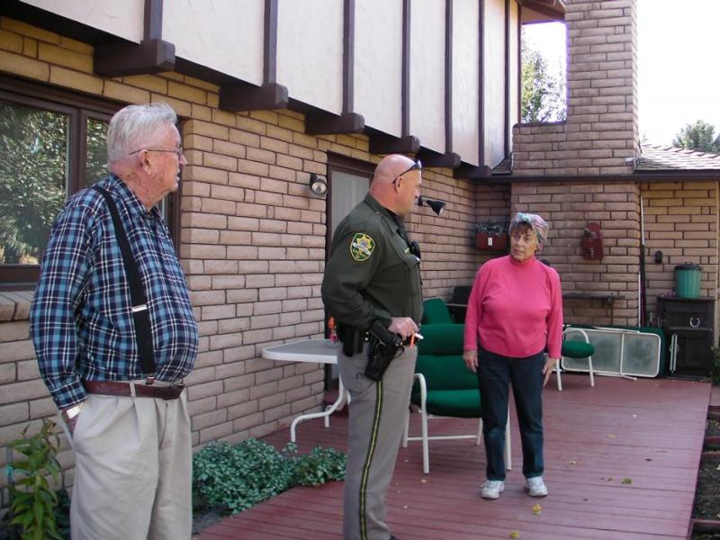 The Hancocks outside their home Saturday with Carson City Deputy Gary Denham.