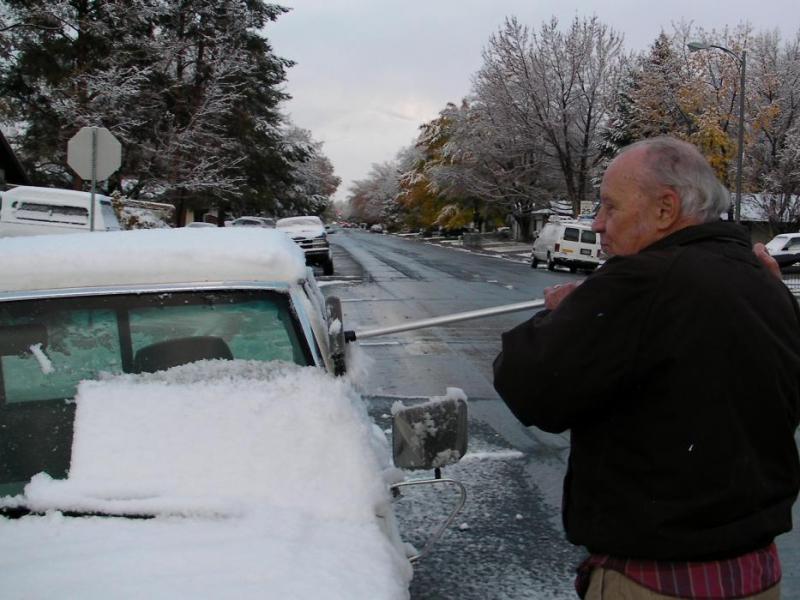 Carson City resident Ed Jackson removes snow from his pickup in Carson City.