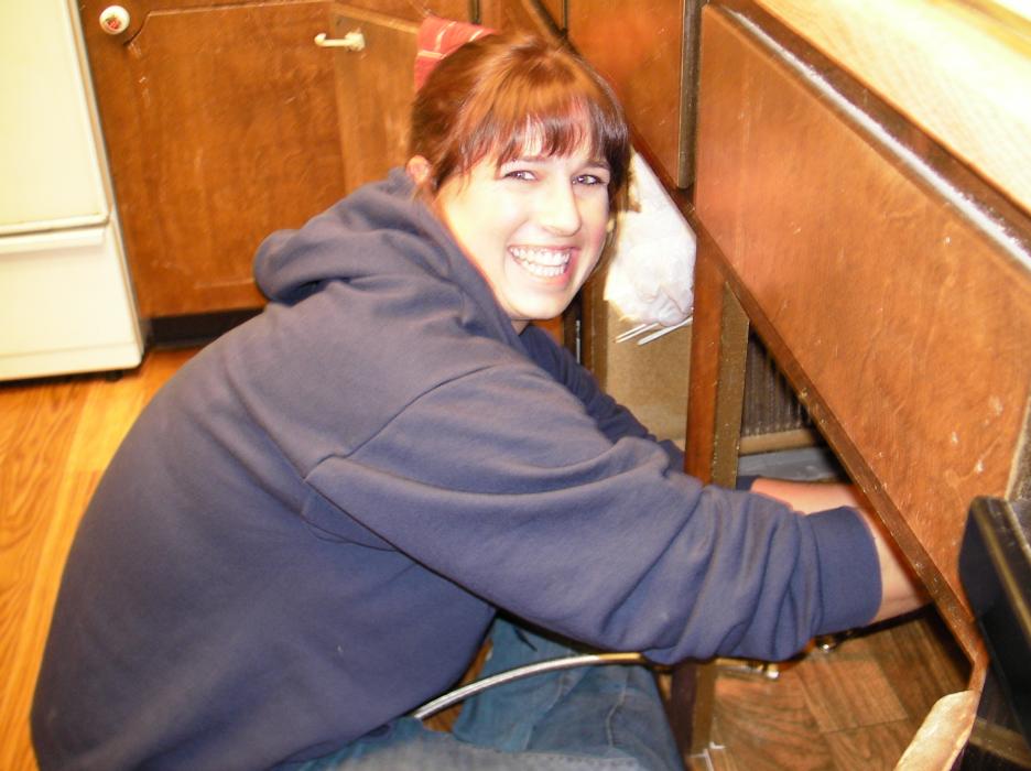 Genna Tonneslan hooks up the plumbing.