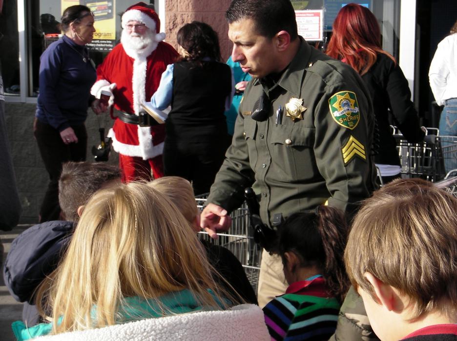 Sgt. Daniel Gonzales prepares the school children for the Walmart shopping event.