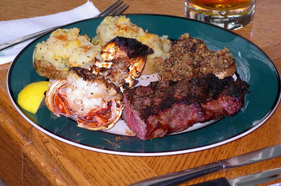 Steak, lobster tail, twice-baked potato and stuffed mushrooms. Photo by Don Quilici